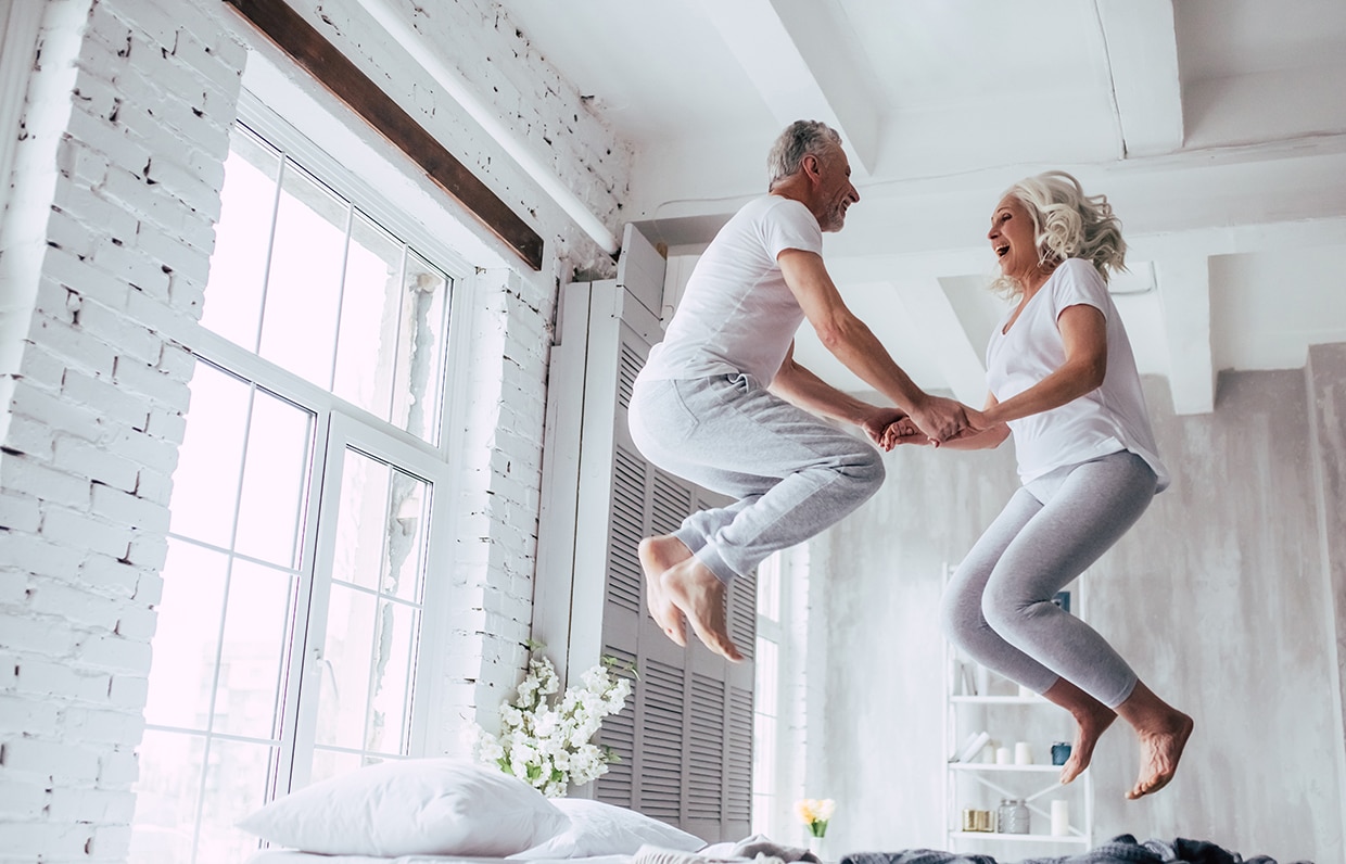 postarší pár skákající na posteli
